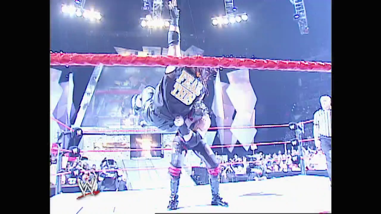 A frame from WWE Raw (February 10, 2003) at 39:32. A wrestler performs in a WWE ring under bright stadium lights, with the iconic red ropes visible and a crowd of spectators in the background. The WWE logo is displayed at the bottom of the screen, capturing the intensity of a live wrestling broadcast from 2003.