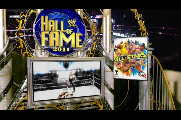 A frame from WWE Raw (March 21, 2011) at 51:20. The WWE Hall of Fame 2011 logo is prominently displayed with blue and gold decorative elements, accompanied by a video screen showing a wrestling scene and promotional graphics for WWE All Stars video game in the arena.