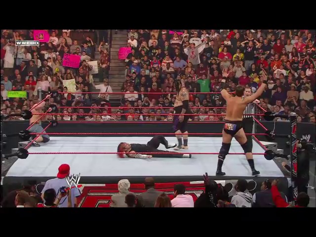 A frame from WWE Raw (May 26, 2008) at 50:06. A shirtless wrestler stands victoriously with arms raised in a WWE Raw ring, while an opponent lies on the mat. The crowd fills the arena around the distinctive red and white wrestling ring, with WWE branding visible on the broadcast graphics.