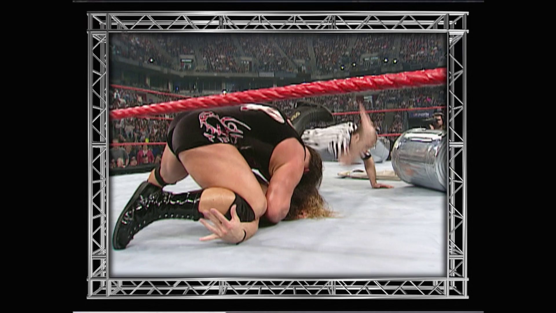 A frame from WWE Raw (April 30, 2001) at 41:13. A wrestler lies on the mat in a wrestling ring during a WWE Raw event, with a packed stadium crowd visible in the background. The red ropes and branding are characteristic of the WWE's signature ring setup from the early 2000s era.