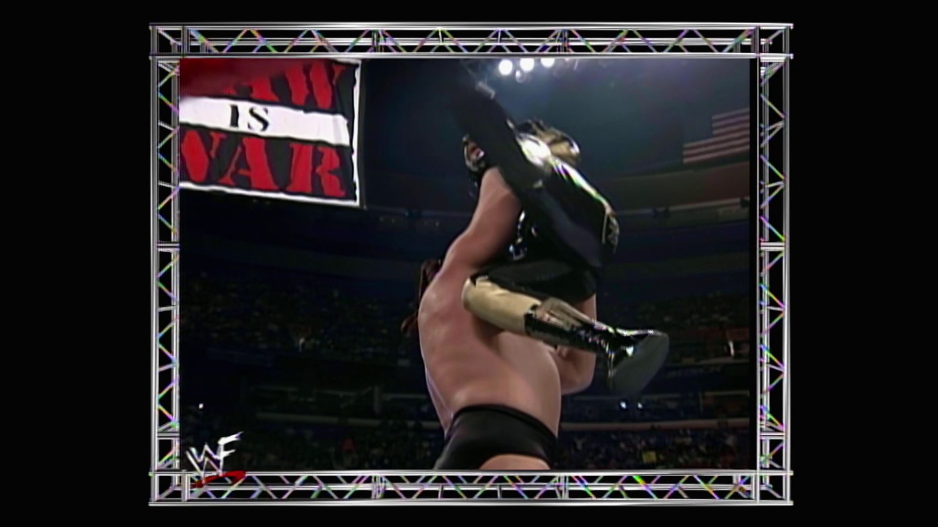 A frame from WWE Raw (May 24, 1999) at 1:21:29. A wrestler holds up a championship belt in a packed arena during a WWE Raw event, with a banner reading "IS AIR" visible in the background and the WWF logo displayed on screen.