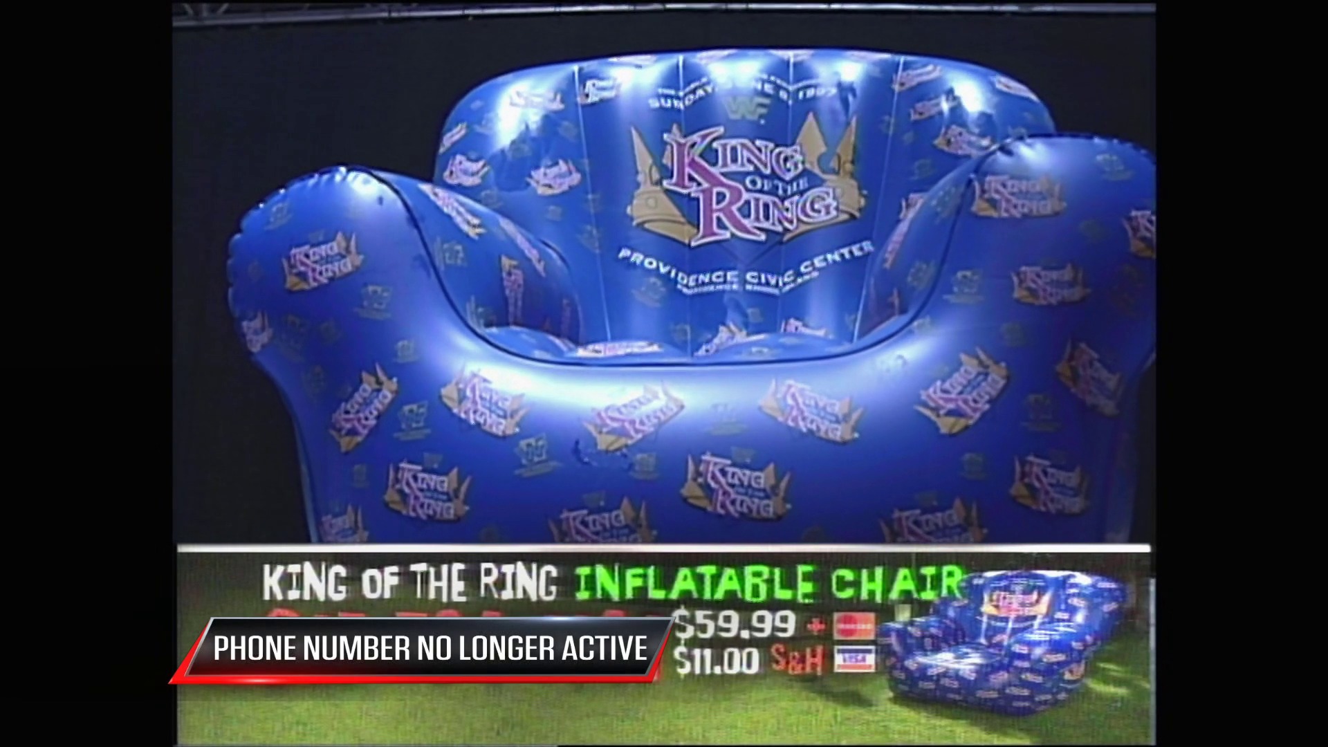 A frame from WWE Raw (May 26, 1997) at 1:06:17. A blue inflatable chair branded with "King of the Ring" and Providence Civic Center logos is displayed on a shopping channel, priced at $59.99 with a $11.00 S&H fee, while a red banner indicates the phone number is no longer active.