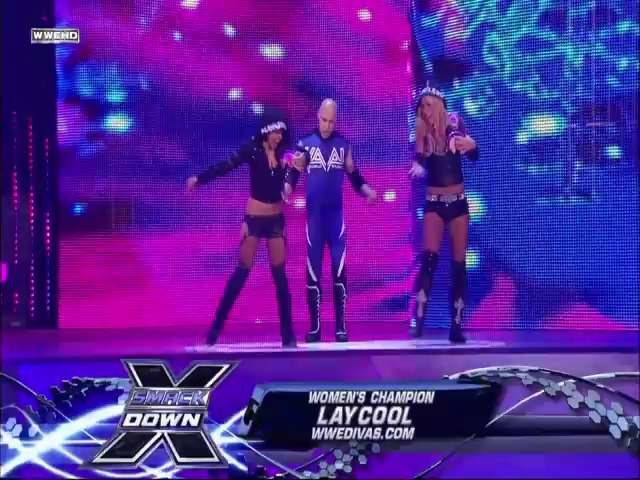 A frame from WWE SmackDown (September 17, 2010) at 47:08. Three female wrestlers perform in the ring under vibrant purple and pink LED lighting during a WWE SmackDown event. The broadcast graphics display "Women's Champion" and "Laycool" at the bottom, with the WWE SmackDown logo visible in the corner.
