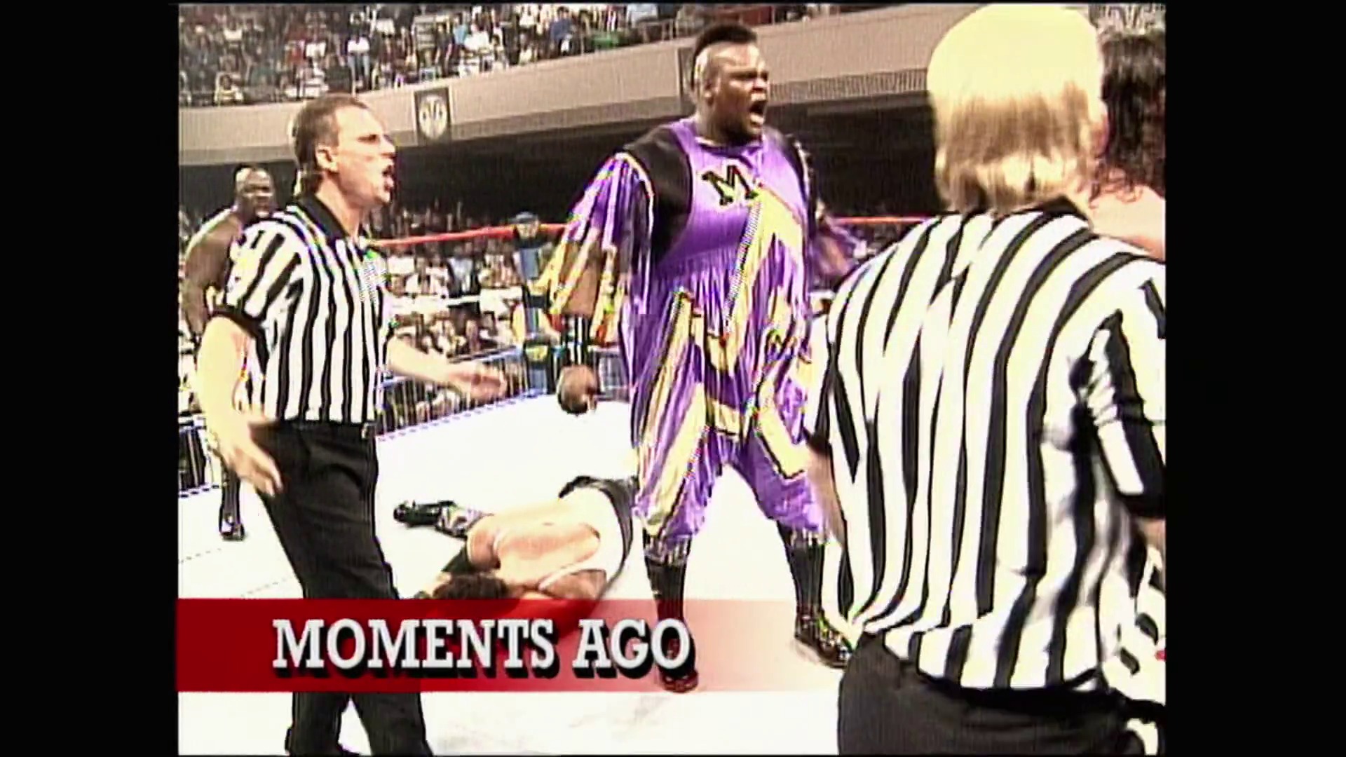 A frame from WWE Raw (August 21, 1995) at 45:49. A wrestler in a purple and gold robe argues with referees in the WWE ring, with a packed stadium crowd visible in the background. The "MOMENTS AGO" caption appears at the bottom of the screen.