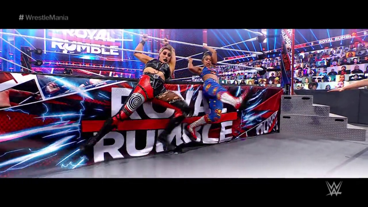 A frame from WrestleMania 37 (2021) at 2:41:51. Two female wrestlers are engaged in action inside a WWE ring during Royal Rumble, with dynamic blue and red lighting, large branded graphics, and a crowd visible in the background at what appears to be a virtual or socially-distanced venue.