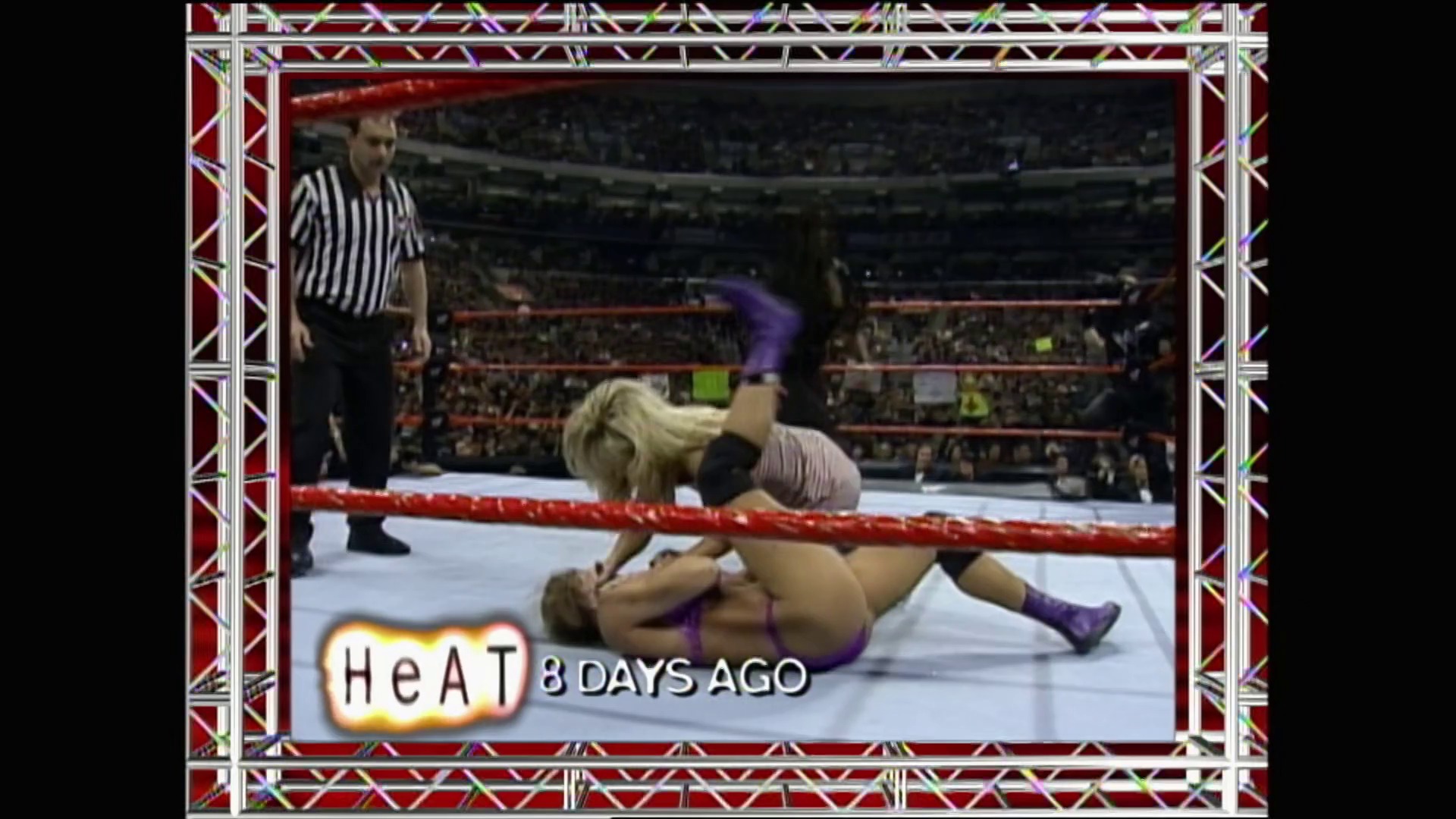 A frame from WWE Raw (April 5, 1999) at 25:22. A WWE Raw broadcast frame from April 5, 1999 captures an intense in-ring moment with a blonde female wrestler on the mat near the red rope, while a referee stands nearby and the crowd fills the arena seats in the background.