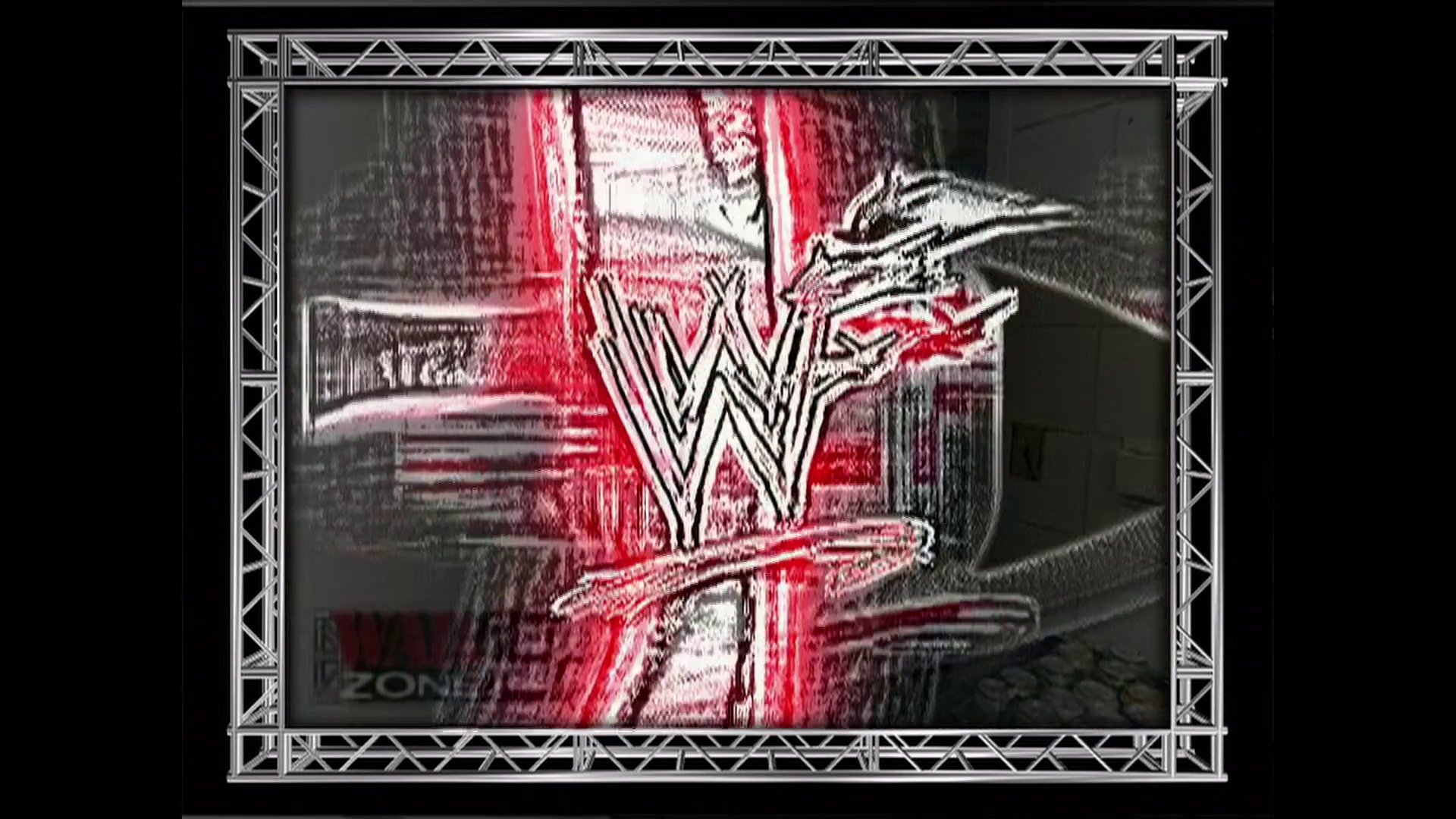 A frame from WWE Raw (August 27, 2001) at 56:53. A WWE Raw broadcast frame displays the iconic white "W" logo centered on screen against a red and black background with dramatic lighting effects, surrounded by a metallic truss-style frame border typical of early 2000s wrestling production design.
