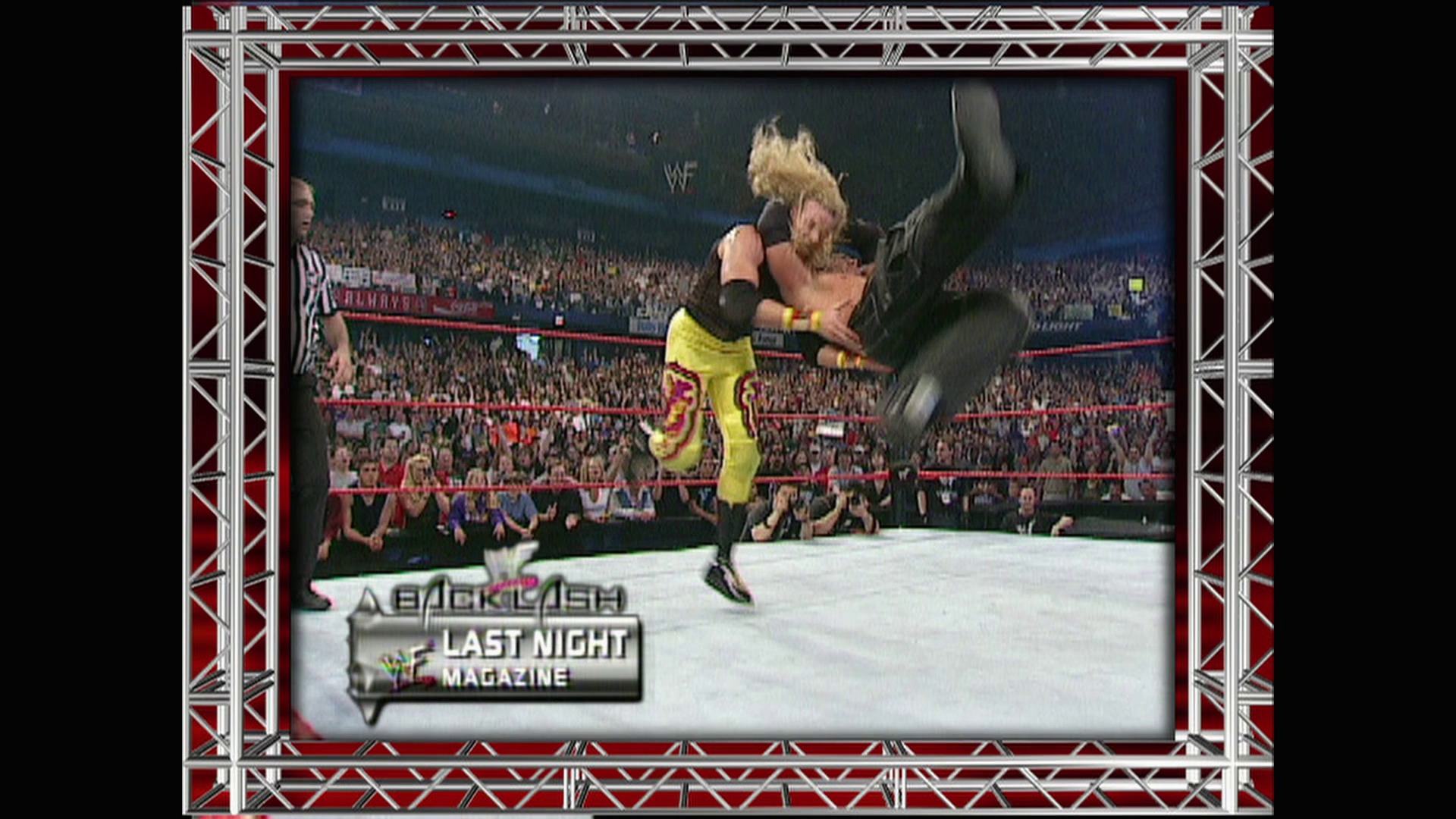 A frame from WWE Raw (April 30, 2001) at 13:25. A wrestler in yellow and purple attire performs an aerial move in the WWE ring, with a packed crowd visible in the background. The "Backlash Last Night Magazine" graphic appears at the bottom of the broadcast frame.