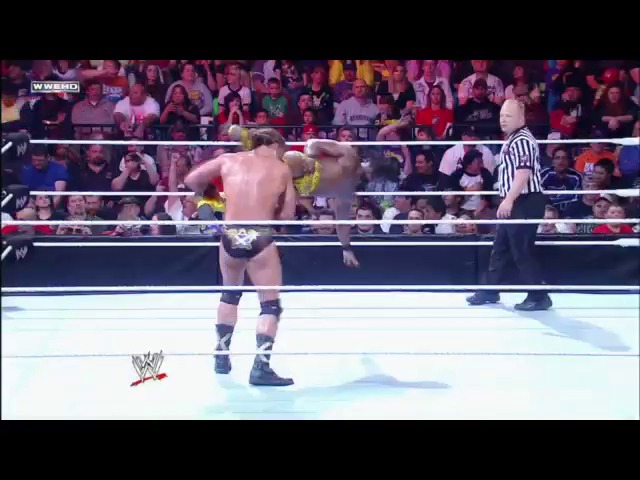 A frame from WWE Raw (May 23, 2011) at 1:03:17. A shirtless wrestler stands in the WWE ring wearing black wrist tape and boots, with a referee visible nearby. The crowd fills the arena in the background while WWE graphics appear at the bottom of the screen.