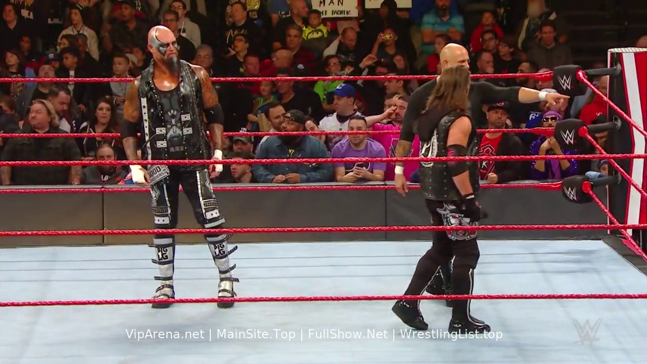 A frame from WWE Raw (November 4, 2019) at 1:29:35. Two wrestlers face off in a WWE Raw match inside the red-roped ring, with an enthusiastic crowd visible in the background. The wrestler on the left wears distinctive black and white attire with face paint, while his opponent in dark clothing prepares for confrontation.