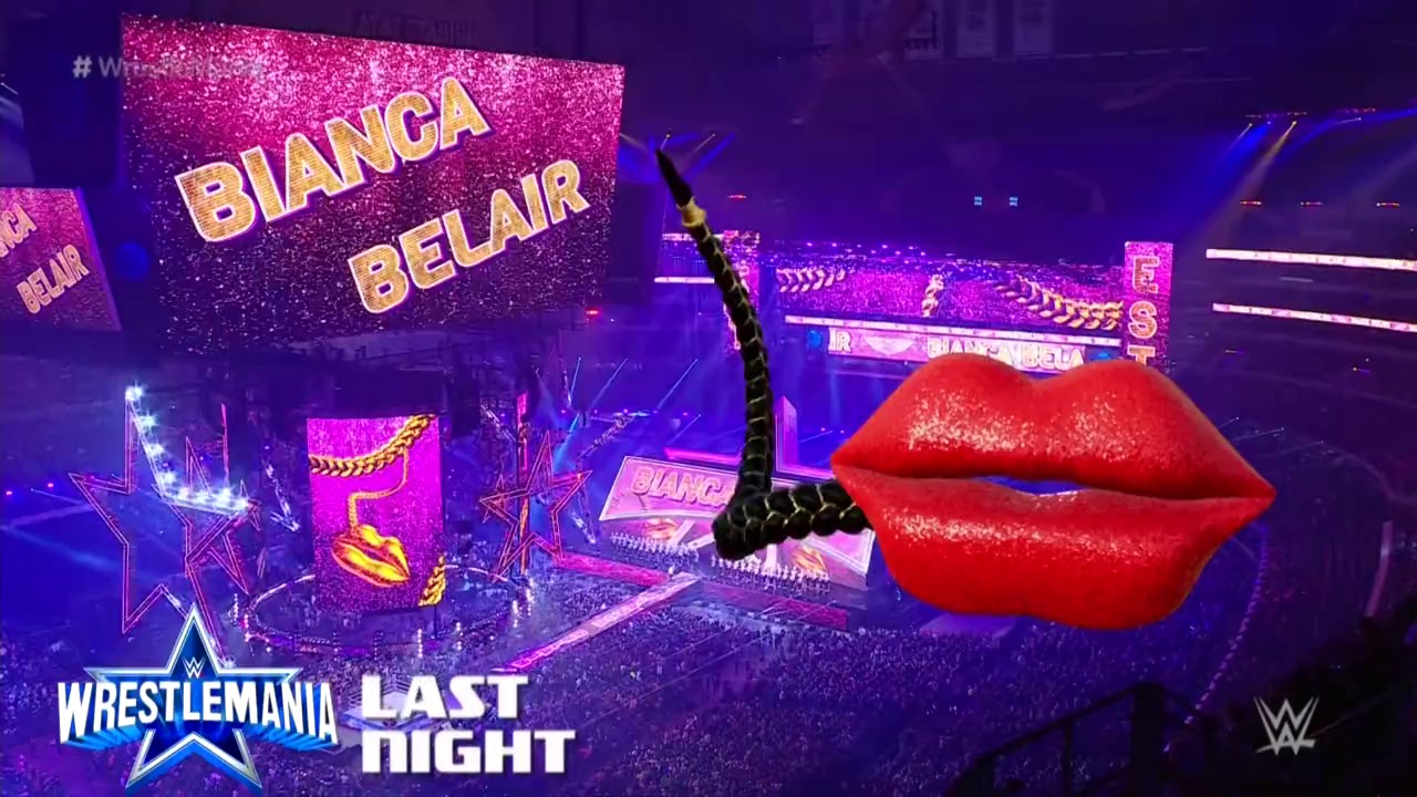 A frame from WWE WrestleMania 38 Sunday (2022) at 3:12:35. A vibrant WWE WrestleMania stage features giant pink glittery "Bianca Belair" signage and a massive red lips prop, set against purple lighting with illuminated star decorations and a packed arena crowd below.