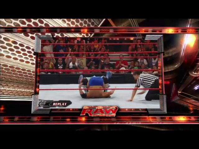 A frame from WWE Raw (March 31, 2008) at 31:24. A WWE Raw broadcast displays a wrestling match in progress, with one wrestler performing a move on an opponent in the ring. The arena crowd is visible in the background, while the "RAW" logo and "REPLAY" indicator appear at the bottom of the screen, along with professional lighting and production graphics typical of WWE television.