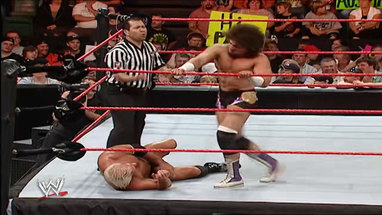 A frame from WWE Raw (May 21, 2007) at 11:54. A WWE wrestler lies on the canvas while another stands nearby as the referee observes. The crowd fills the arena around the red-roped ring during this intense Raw match moment.