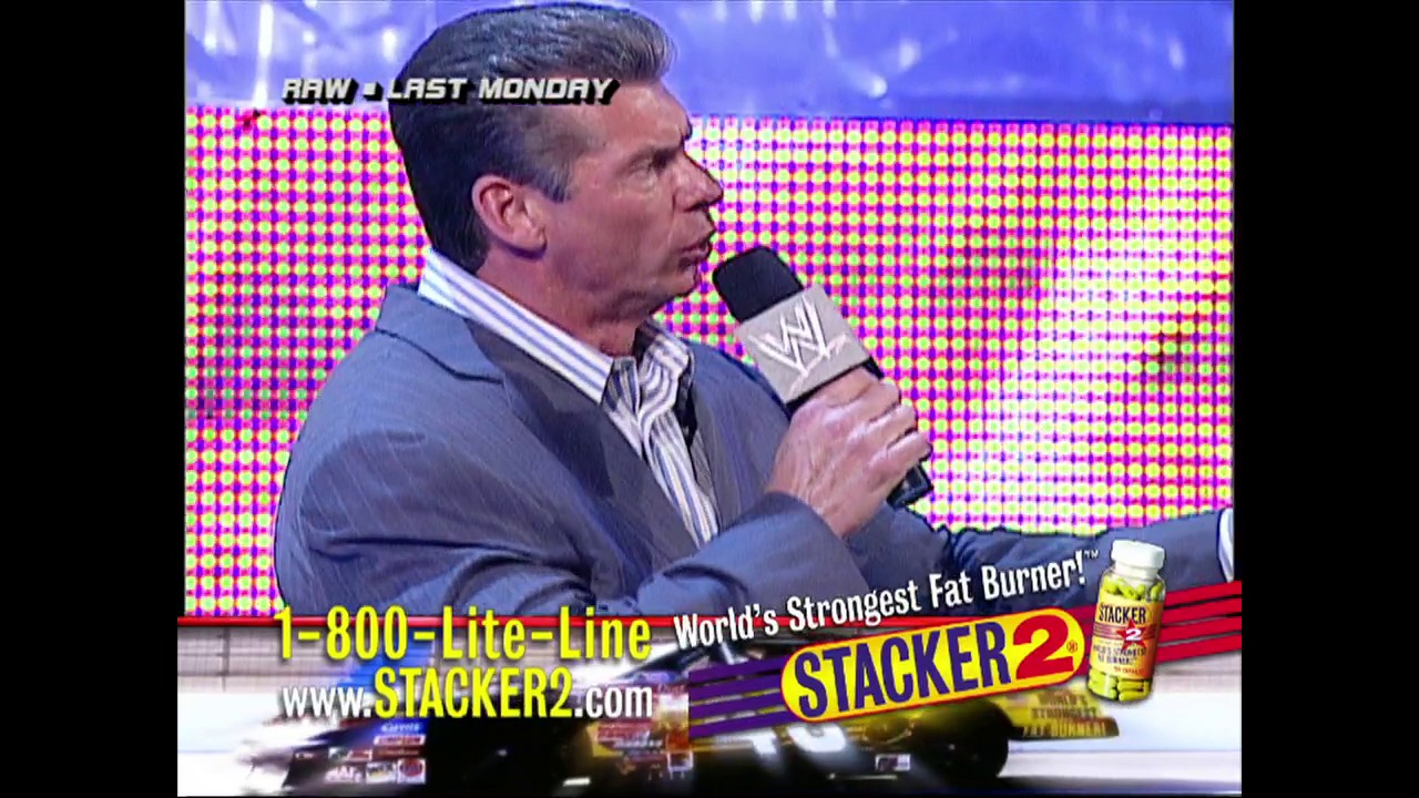 A frame from WWE Raw (July 18, 2002) at 49:53. A WWE announcer in a blue suit holds a microphone during Raw, with a vibrant pink and yellow LED screen backdrop. A Stacker2 fat burner product advertisement is prominently displayed at the bottom of the screen.