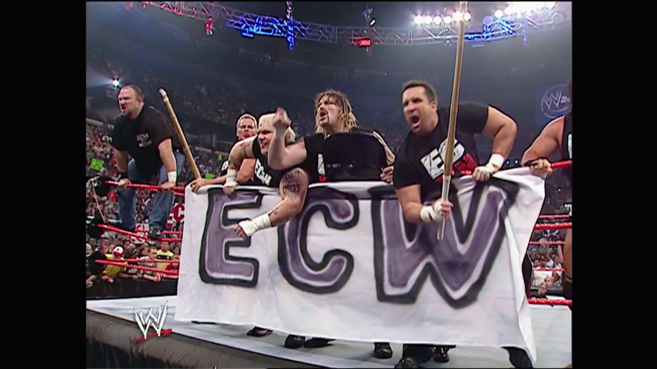A frame from WWE Raw (June 6, 2005) at 1:36:51. WWE wrestlers celebrate in the ring while holding a large "ECW" banner, with a packed arena crowd visible in the background and neon signage overhead during a Raw broadcast.