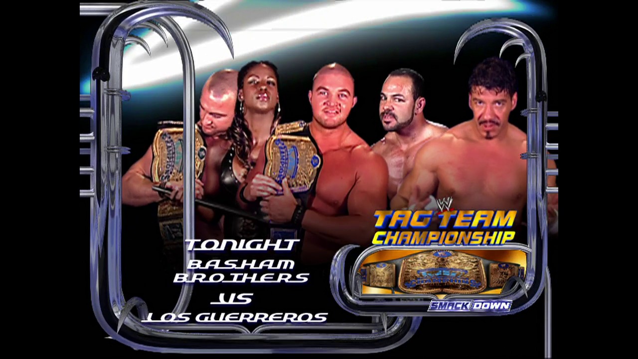 A frame from WWE SmackDown (November 13, 2003) at 1:10. A WWE SmackDown promotional graphic featuring the Basham Brothers versus Los Guerreros in a Tag Team Championship match, with five male wrestlers posed shirtless displaying championship belts against a dark background with futuristic metallic framing.