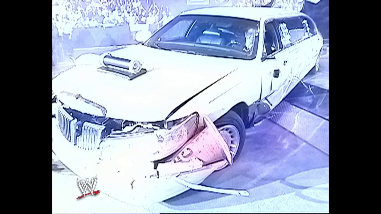 A frame from WWE SmackDown (June 17, 2004) at 24:11. A white lowrider car with a custom hood scoop is positioned in front of a pink vehicle during a WWE SmackDown event, with the WWE logo visible in the lower left corner of the screen.