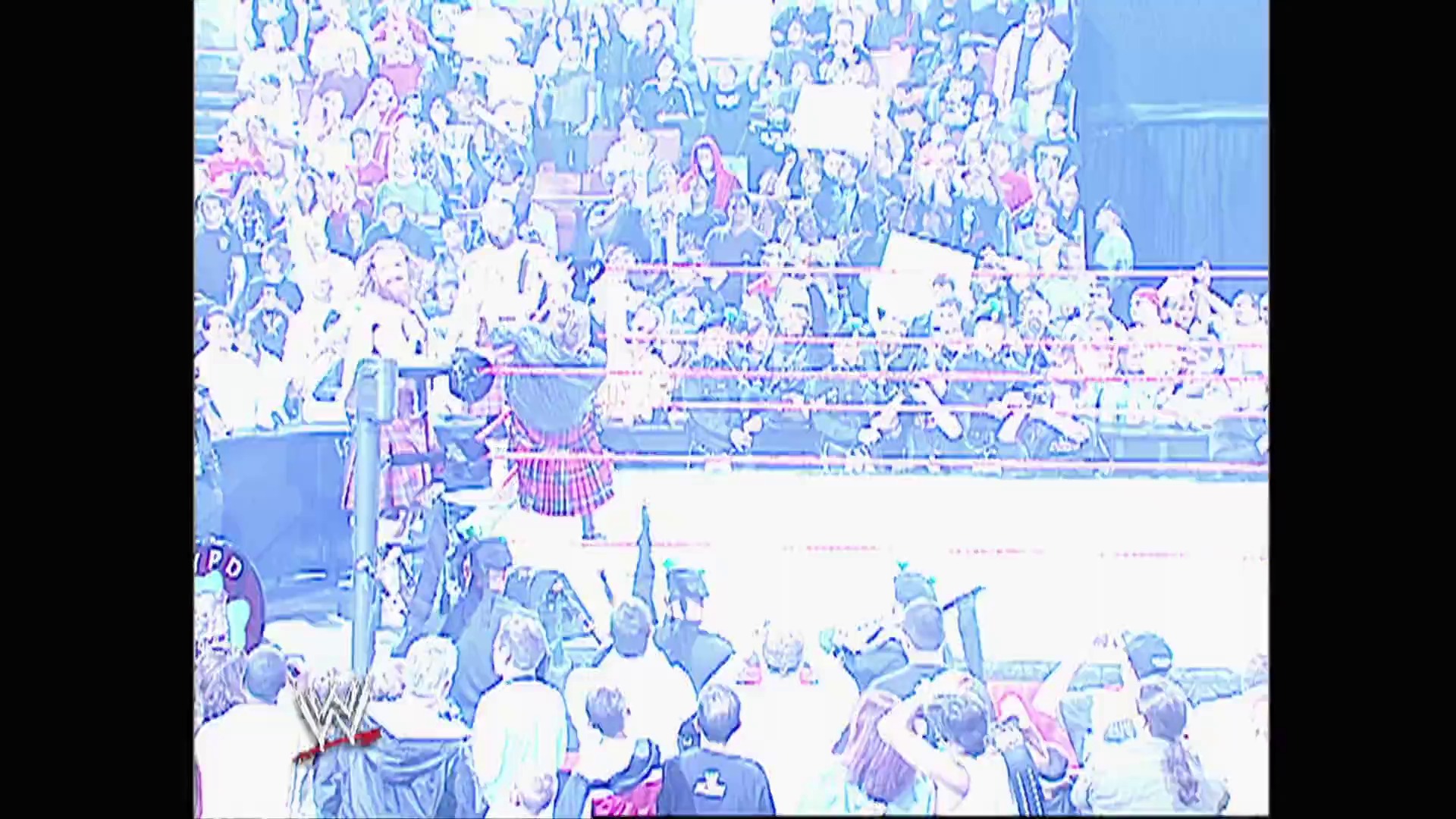 A frame from WWE Raw (September 11, 2006) at 14:46. A WWE wrestler in a pink/red outfit stands in the ring before a packed stadium crowd. The arena is filled with spectators in the stands, with the wrestling ring visible in the foreground and typical WWE broadcast graphics and signage visible around the venue.