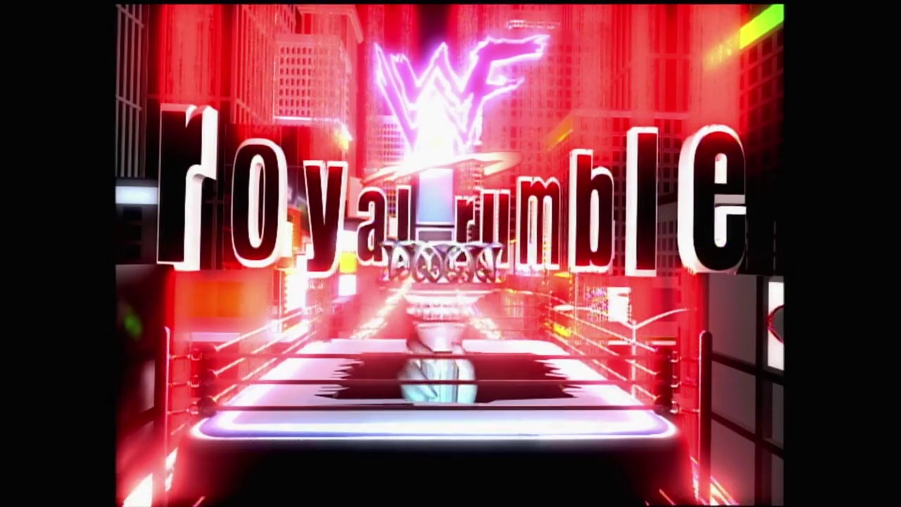 A frame from Royal Rumble (2000) at 1:16. A vibrant wrestling arena bathed in red neon lighting features the WWE Royal Rumble logo and the WWF logo prominently displayed above an illuminated wrestling ring, creating an intense, high-energy atmosphere typical of early 2000s wrestling production.