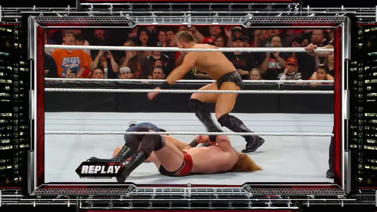 A frame from WWE Raw (February 21, 2011) at 1:28:15. # WWE Raw Match Replay

A wrestler lies prone on the mat while another stands over him in the ring, with an engaged crowd visible in the background. A "REPLAY" graphic appears in the lower left corner of the broadcast frame.