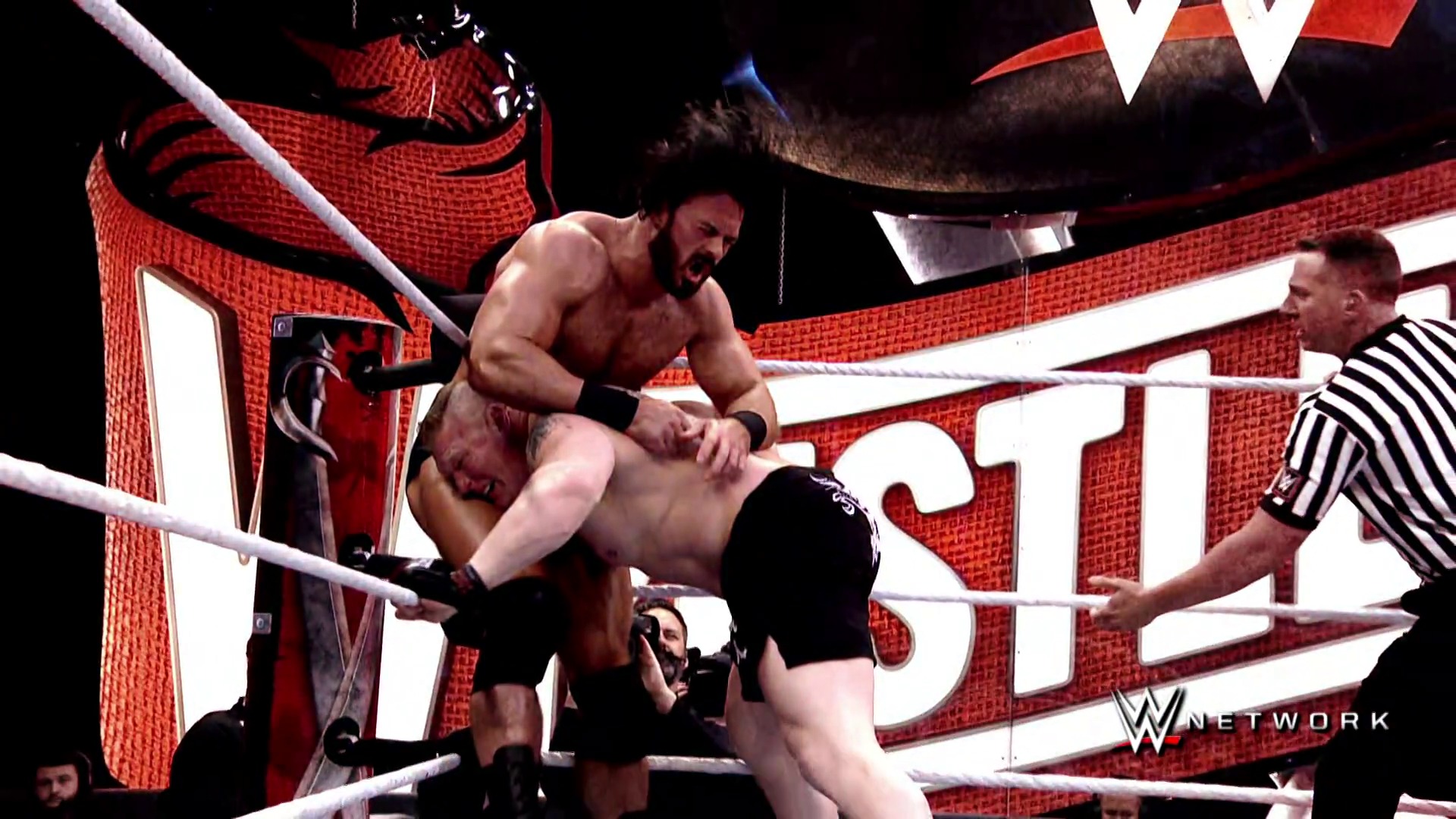 A frame from WWE Raw - S2020E2020 (1993) at 1:44:06. # WWE Raw Wrestling Match

Two wrestlers compete in the ring during an intense match, with one performing a move on his opponent. A referee in striped attire supervises the action, while the red-themed WWE branding and "W Network" logo are visible in the background.