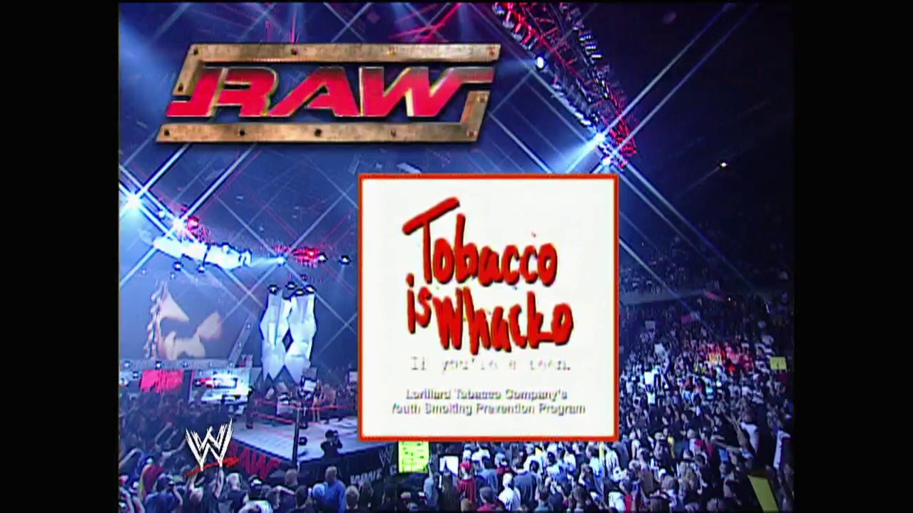 A frame from WWE Raw (August 4, 2003) at 26:01. A WWE Raw broadcast screen displays the "Tobacco is Whack" public health message overlay on a wrestling arena filled with spectators. The WWE logo appears at the top with the arena crowd visible in the background.