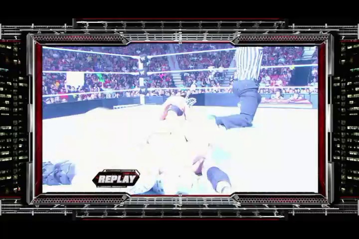 A frame from WWE Raw (July 4, 2011) at 52:39. A wrestler lies on the mat during a replay sequence at WWE Raw, with a packed arena crowd visible in the background and the distinctive "REPLAY" graphic displayed in the lower left corner of the broadcast.