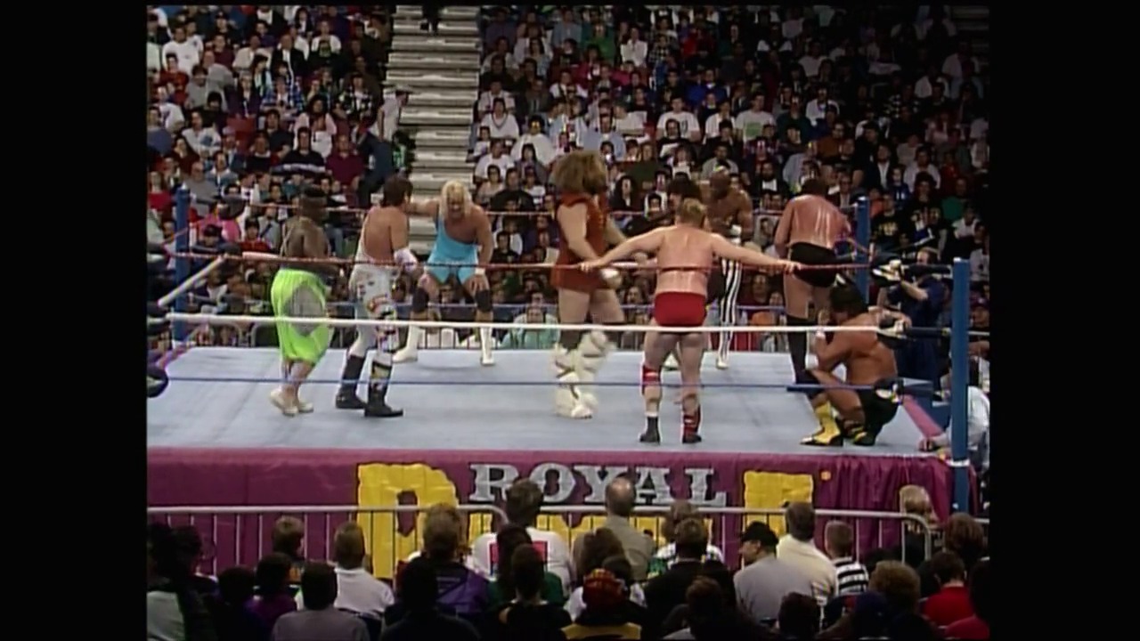 A frame from Royal Rumble (1993) at 1:52:30. Multiple female wrestlers compete in a match inside a WWF wrestling ring during Royal Rumble 1993, with a packed crowd visible in the stadium stands behind them.