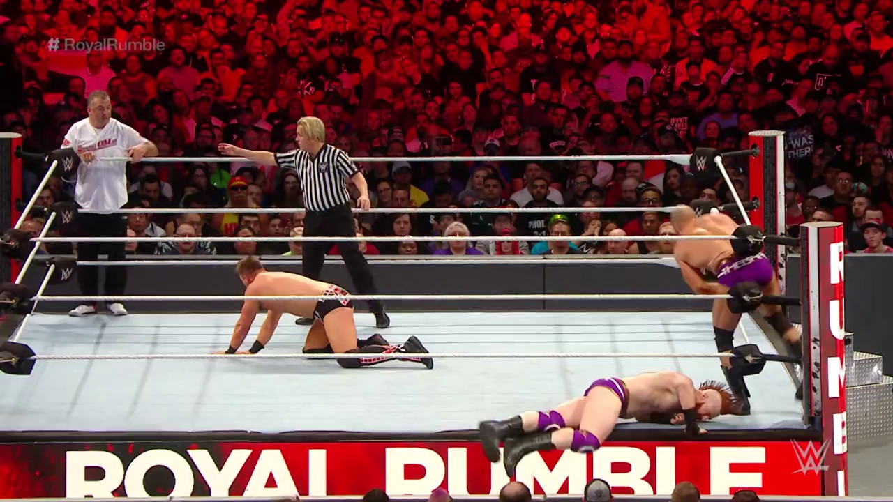 A frame from WWE Royal Rumble (2019) at 40:39. A WWE Royal Rumble match in progress shows multiple wrestlers in a ring with a referee in striped shirt. The crowd fills the red-lit arena behind the ropes, while the event logo and hashtag #RoyalRumble are visible at the bottom of the frame.