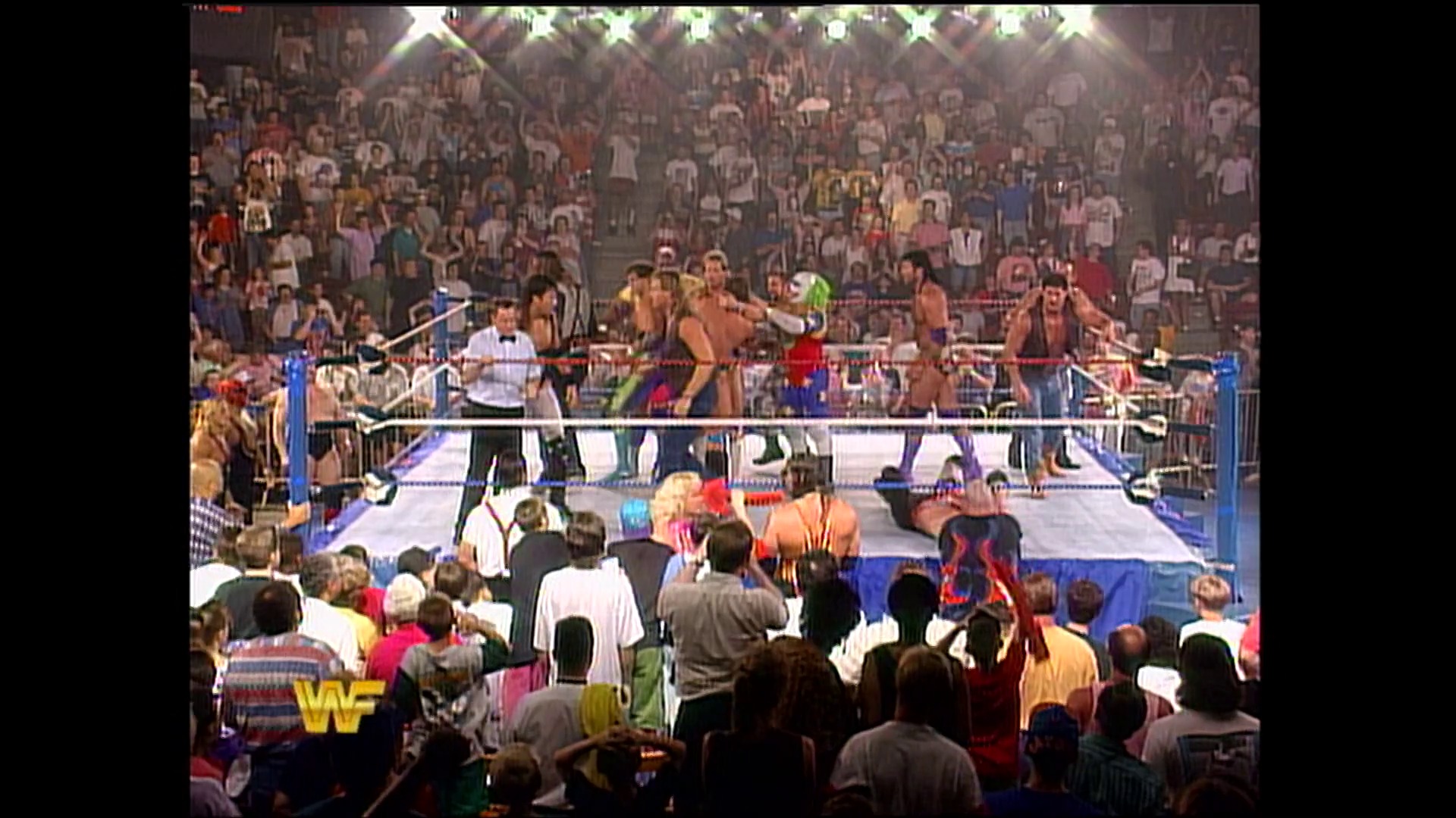 A frame from WWE Raw (June 6, 1994) at 20:10. # WWE Raw Wrestling Event

A packed arena features wrestlers competing in a blue-roped ring during an intense match, with thousands of spectators filling the stands under bright lights. The WF logo is visible in the lower left corner of the broadcast.