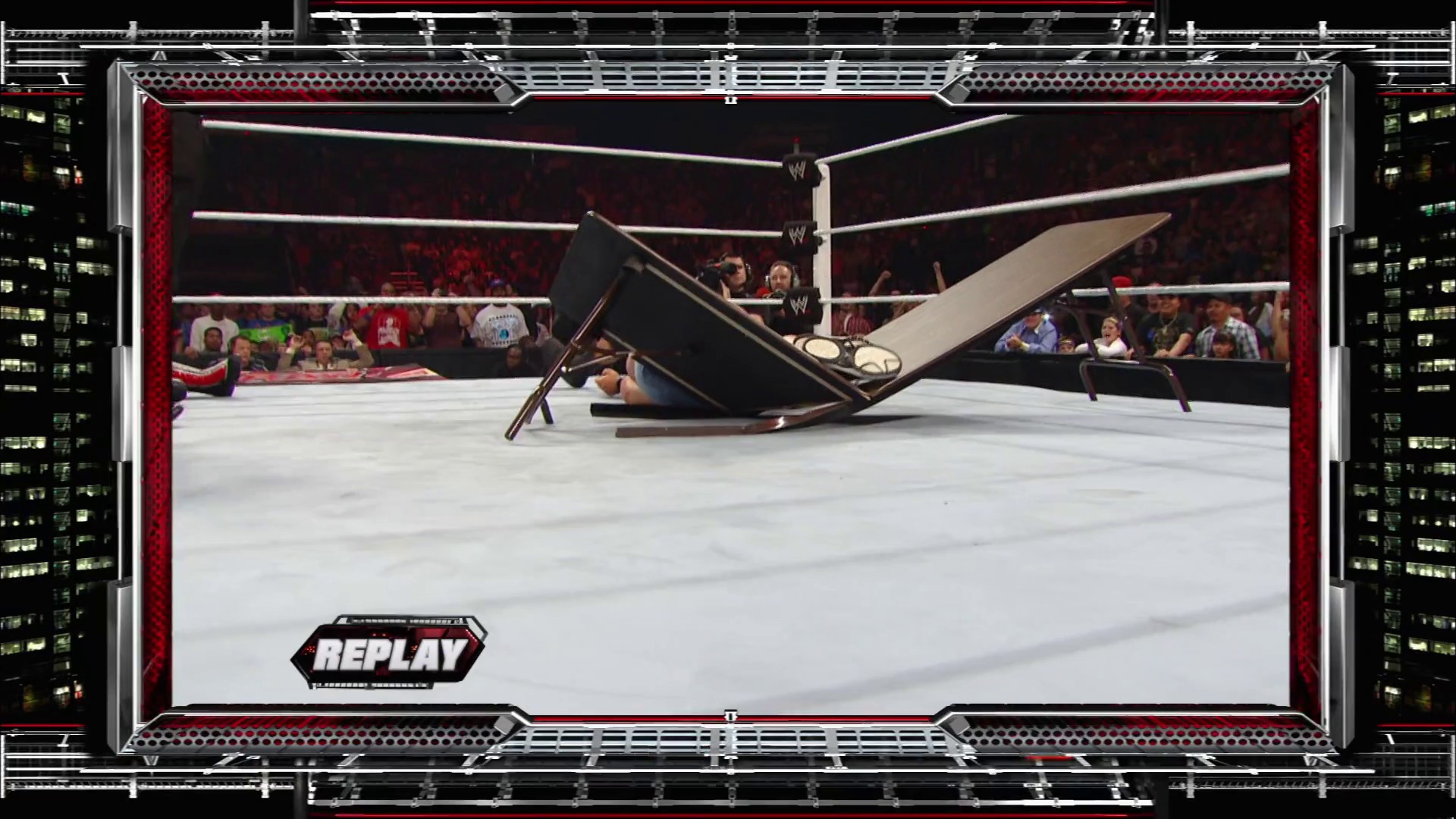 A frame from WWE Raw (September 13, 2010) at 1:29:08. A wrestler lies on the WWE ring canvas during a replay moment, with a steel chair positioned nearby. The crowd is visible in the background behind the red ropes, with the "REPLAY" graphic displayed in the lower left corner.