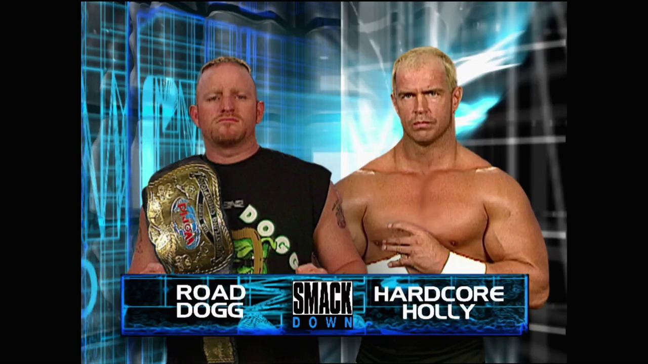 A frame from WWE SmackDown (October 7, 1999) at 10:43. Two wrestlers face the camera on WWE SmackDown, with "Road Dogg" holding a championship belt on the left and "Hardcore Holly" shirtless on the right. The blue-tinted digital background features the SmackDown logo and on-screen graphics identifying both competitors.